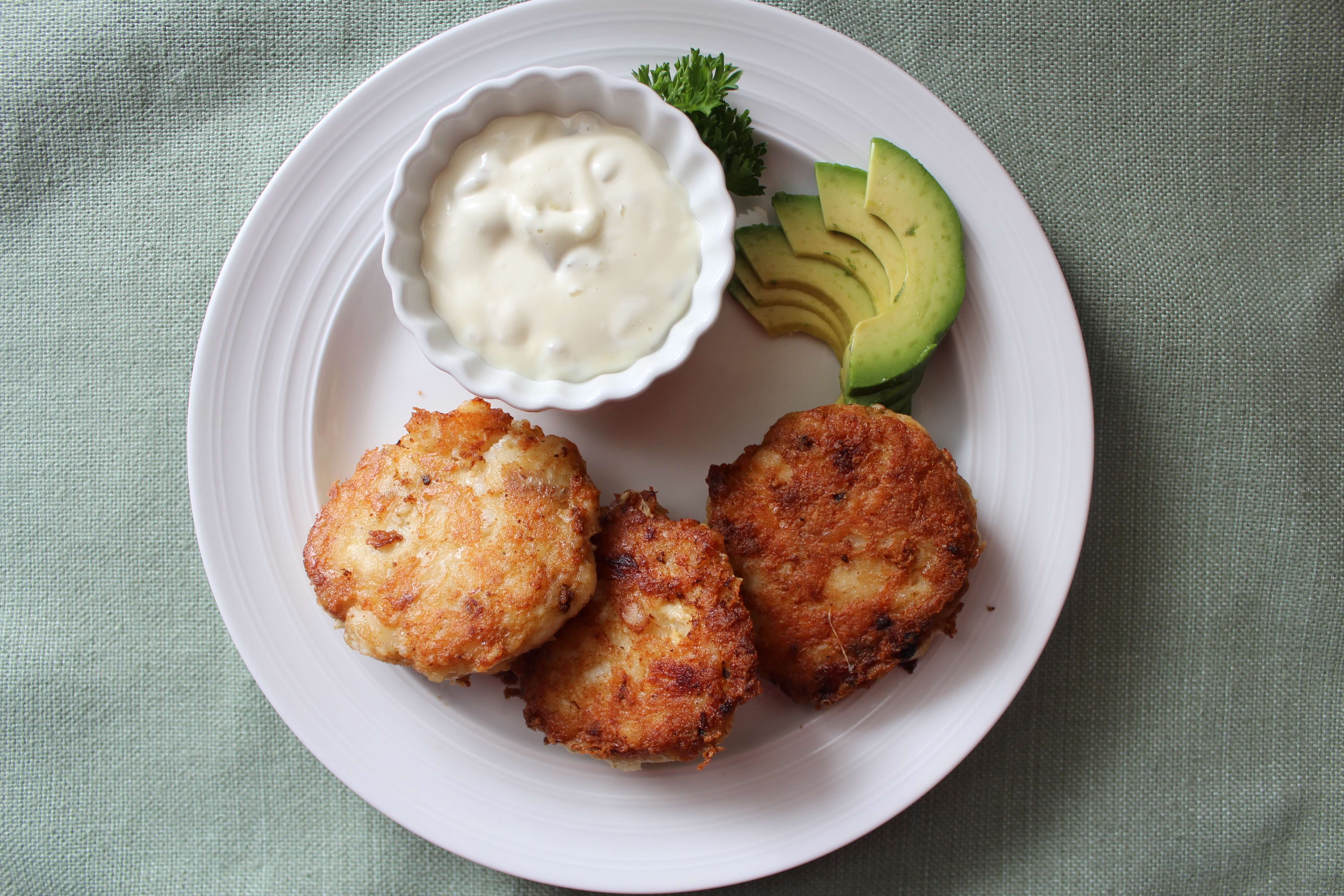 Montana Walleye fish patties with tartar sauce and avocado