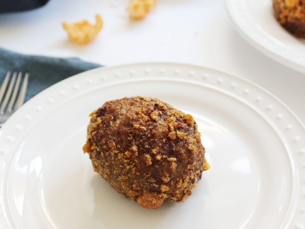 Gluten Free Scotch Egg on a plate before cutting