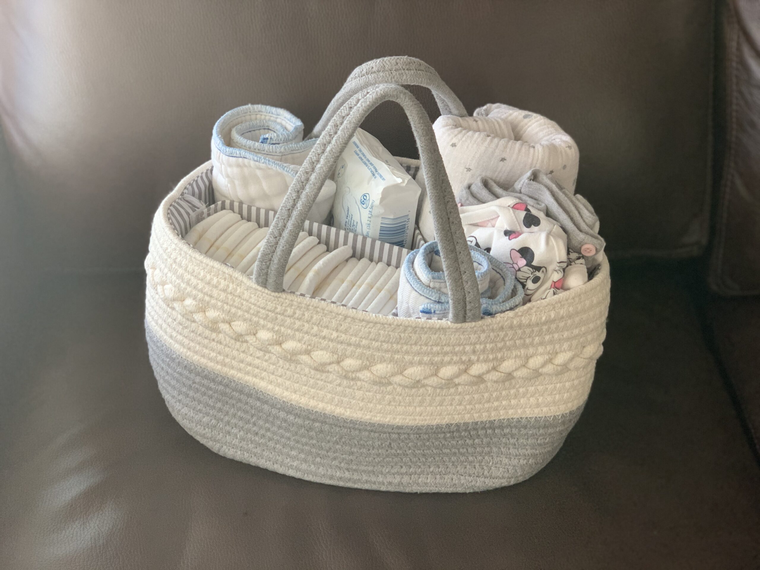 Basket filled with newborn essentials to keep in the living room to help minimize going up and down stairs